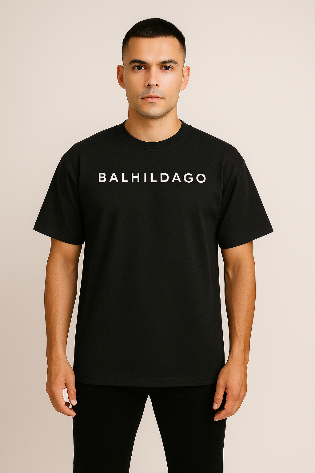 Confident male model wearing Desmond & Florence BALHILDAGO Oversized Tee in Faded Black, front studio view
